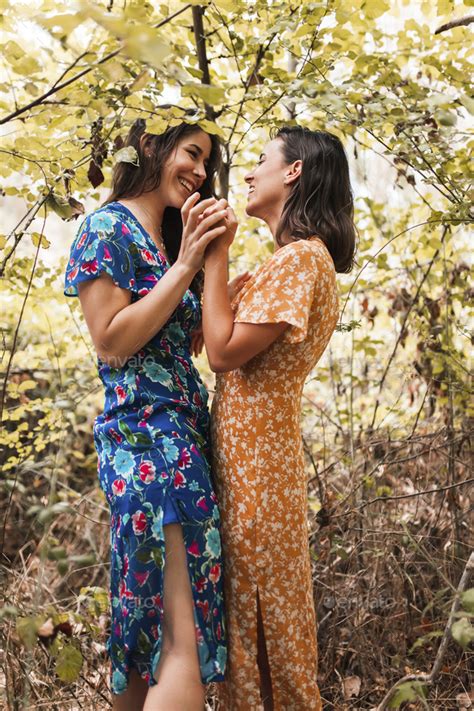 lesbians in the woods|Two young lesbians caressing each other in the woods.